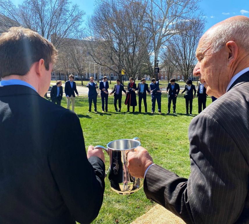 Interim Chapter Adviser Phil Eskew ‘63 passes the Loving Cup at Beta’s spring 2023 initiation.